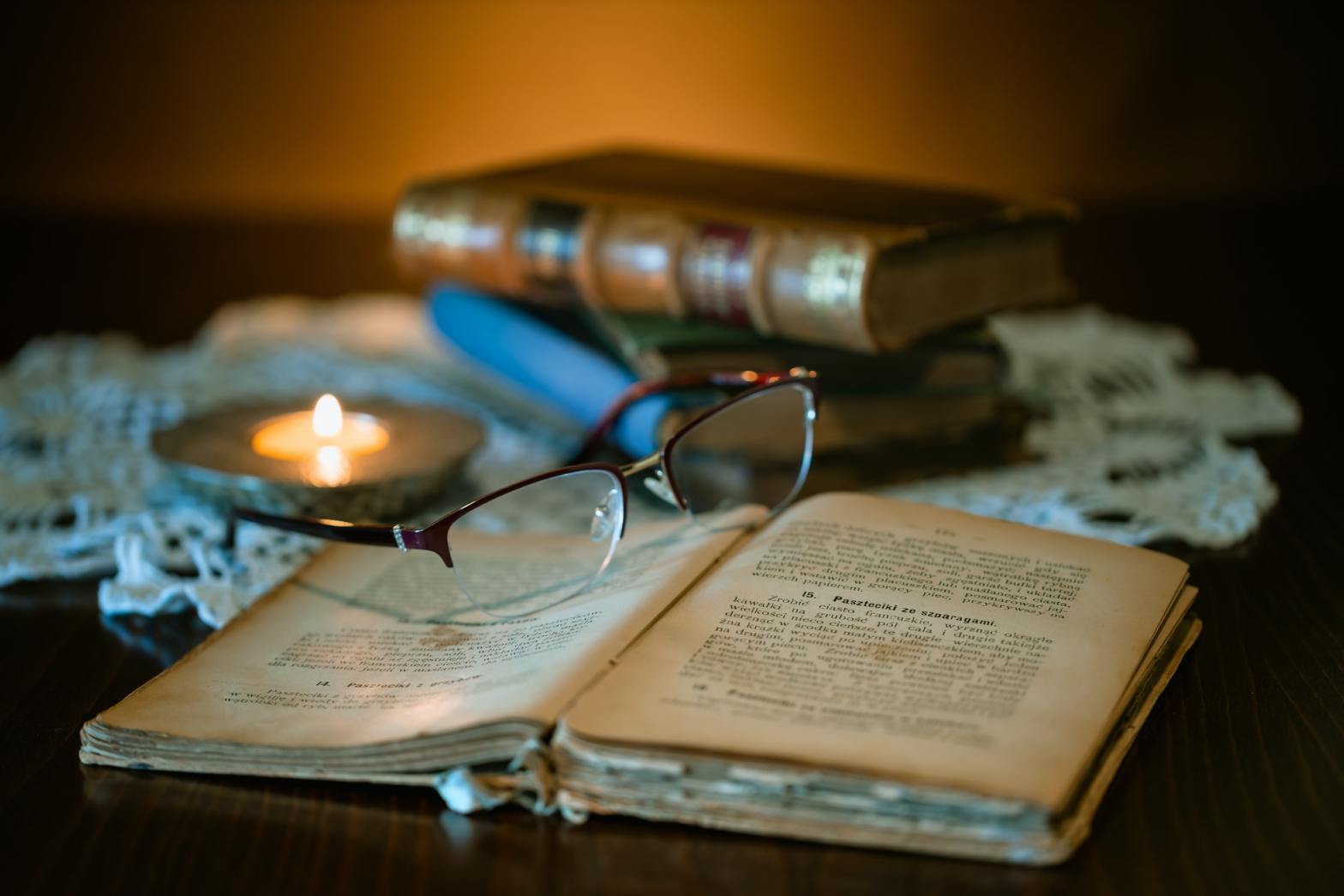 An old open book with glasses on top