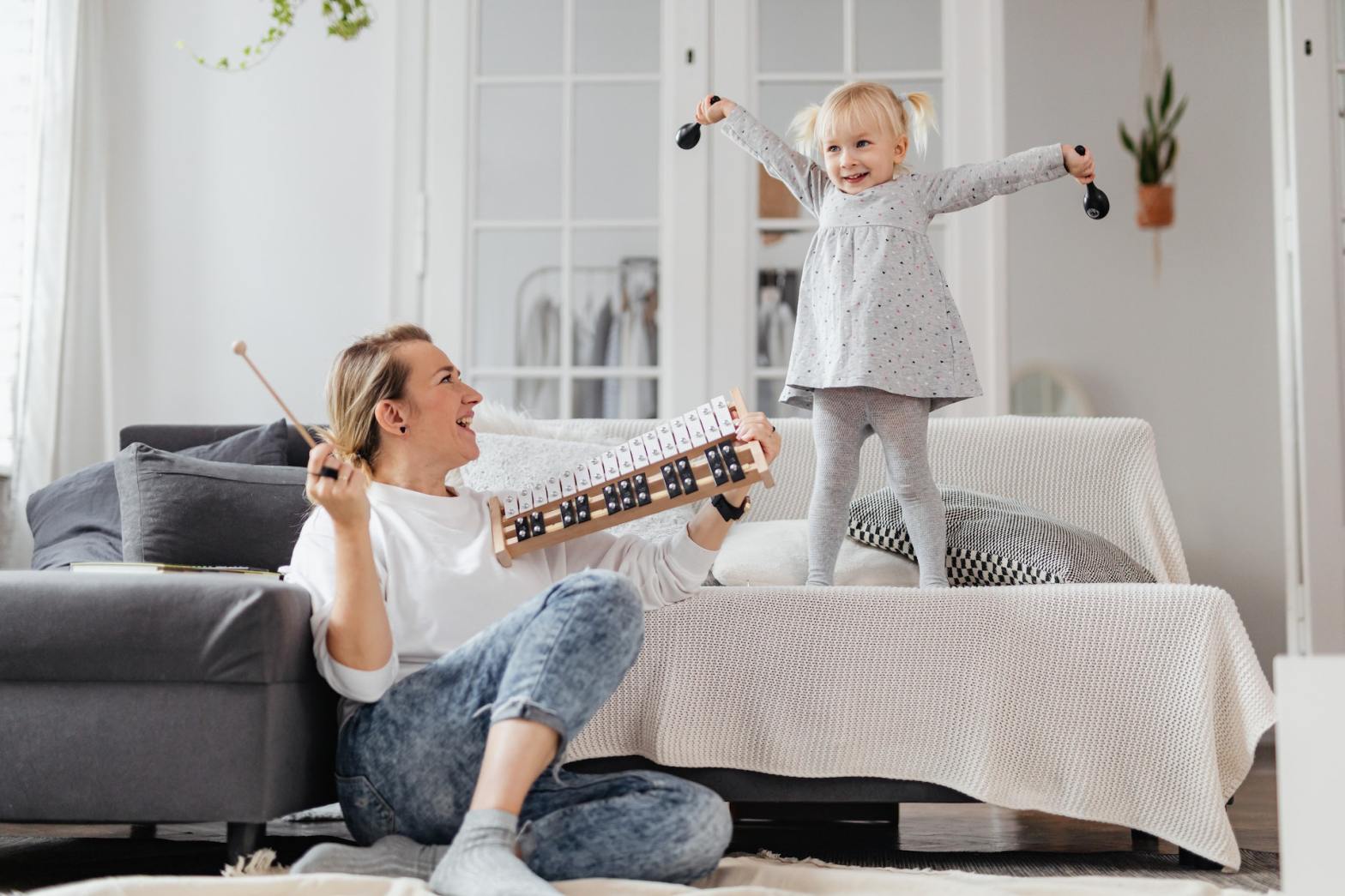 mom and daughter playing instruments using music to tell stories